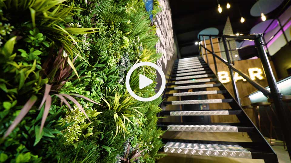 metal staircase and artificial plants in a showroom